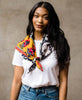 woman in white t-shirt and jeans wearing an anchal vintage kantha square scarf tied around her shoulders