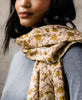 Woman wearing lightweight cotton vintage kantha scarf
draped around her neck