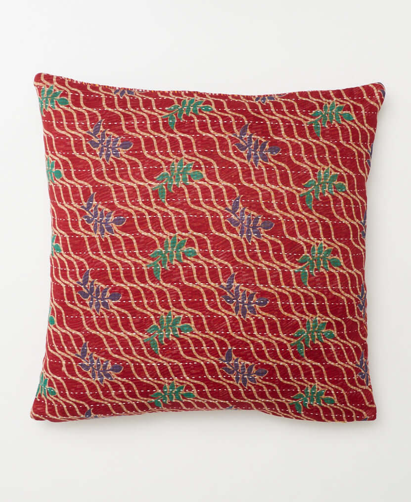 red swirl patterned square pillow with indigo & green leaf print