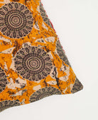 ethically made square pillow with orange and black and white medallion pattern