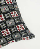 black and grey checkered throw pillow made from eco-friendly vintage fabrics by artisans in India and hand-embroidered