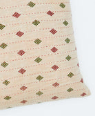 square pillow featubg a diaomnbd pattern 