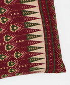 square pillow in hues of burgundy hand made by women 