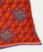 square pillow crafted by aristans in india using an orange and purple floral pattern 