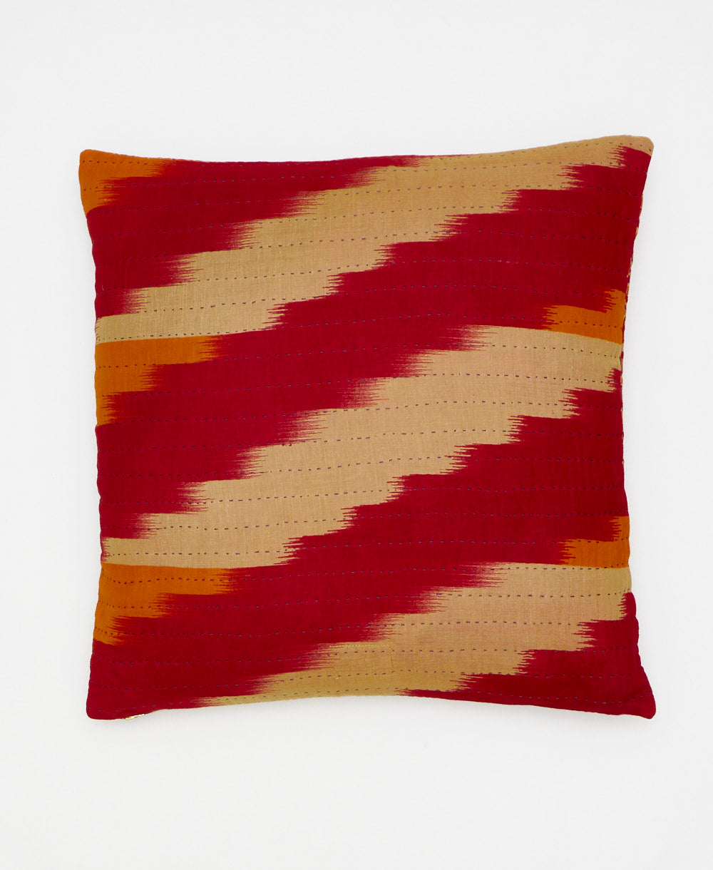 colorful throw pillow featuring an orange paisley pattern and traditional kantha hand stitching 