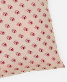 square pillow featuring a red floral pattern and traditional kantha hand stitching