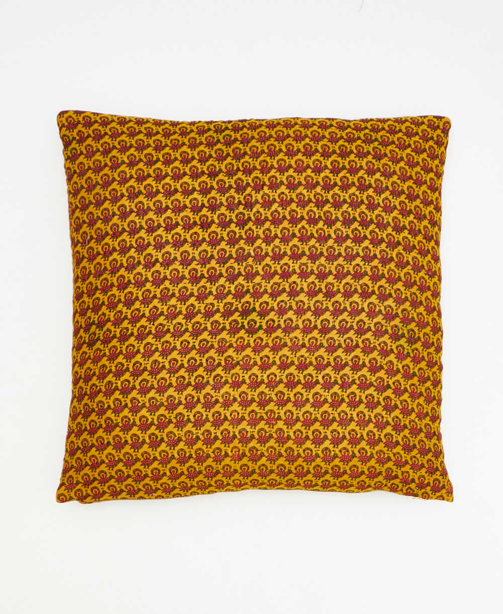 mustard throw pillow with a hot pink peacock print made from vintage cotton saris in India