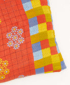 kantha square pillow in coral with multi-colored checkered pattern pattern with grey embroidery