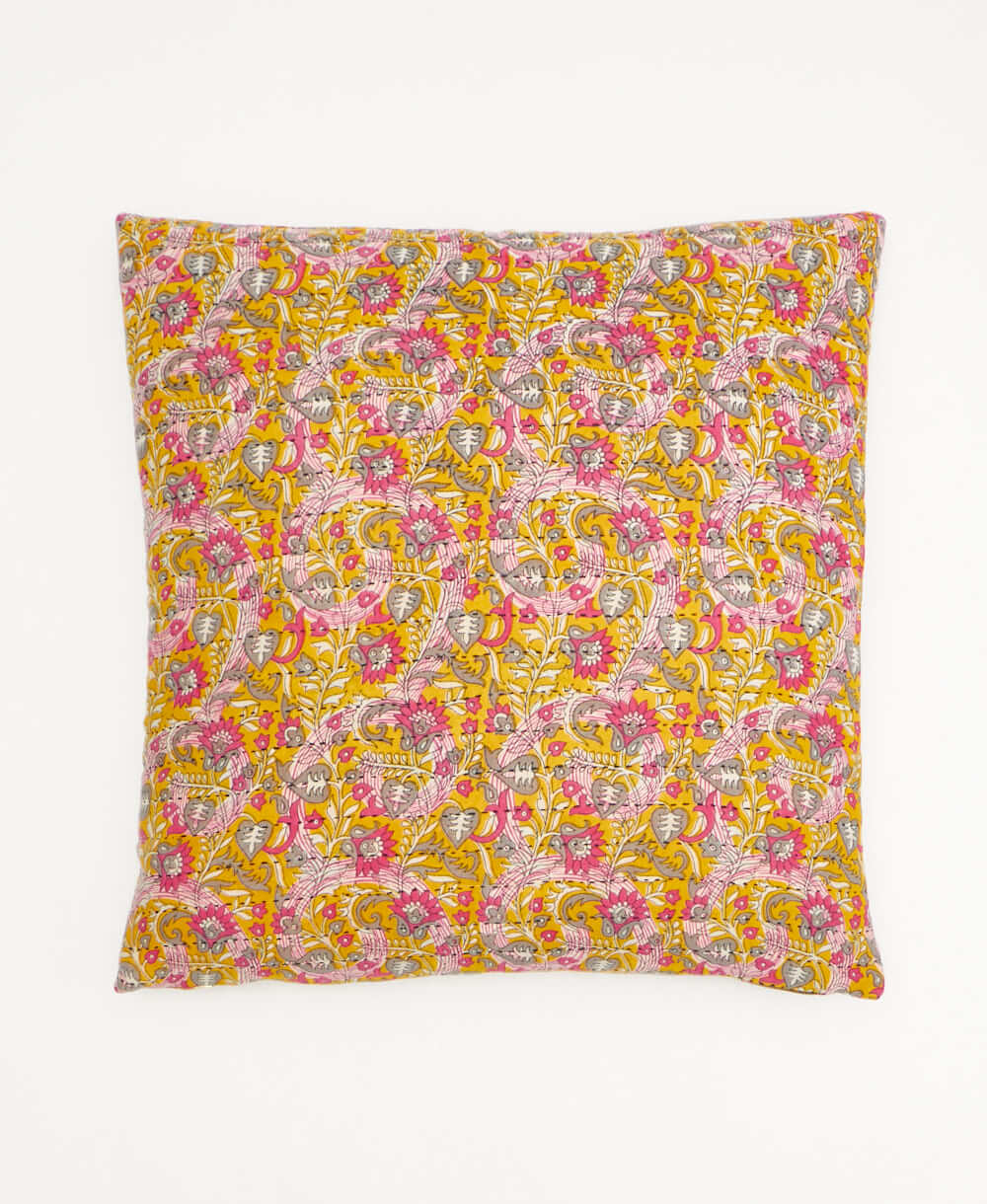 colorful throw pillow in barbie pink made from vintage fabrics with hand-stitched embroidery in yellow paisley print