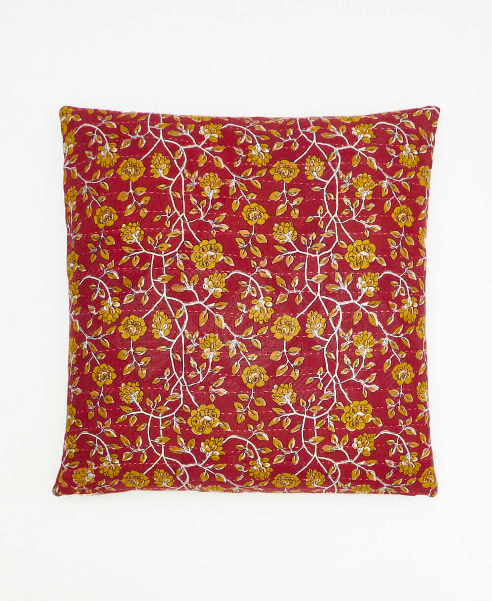 colorful throw pillow in brick red made from vintage fabrics with hand-stitched embroidery in lime floral print