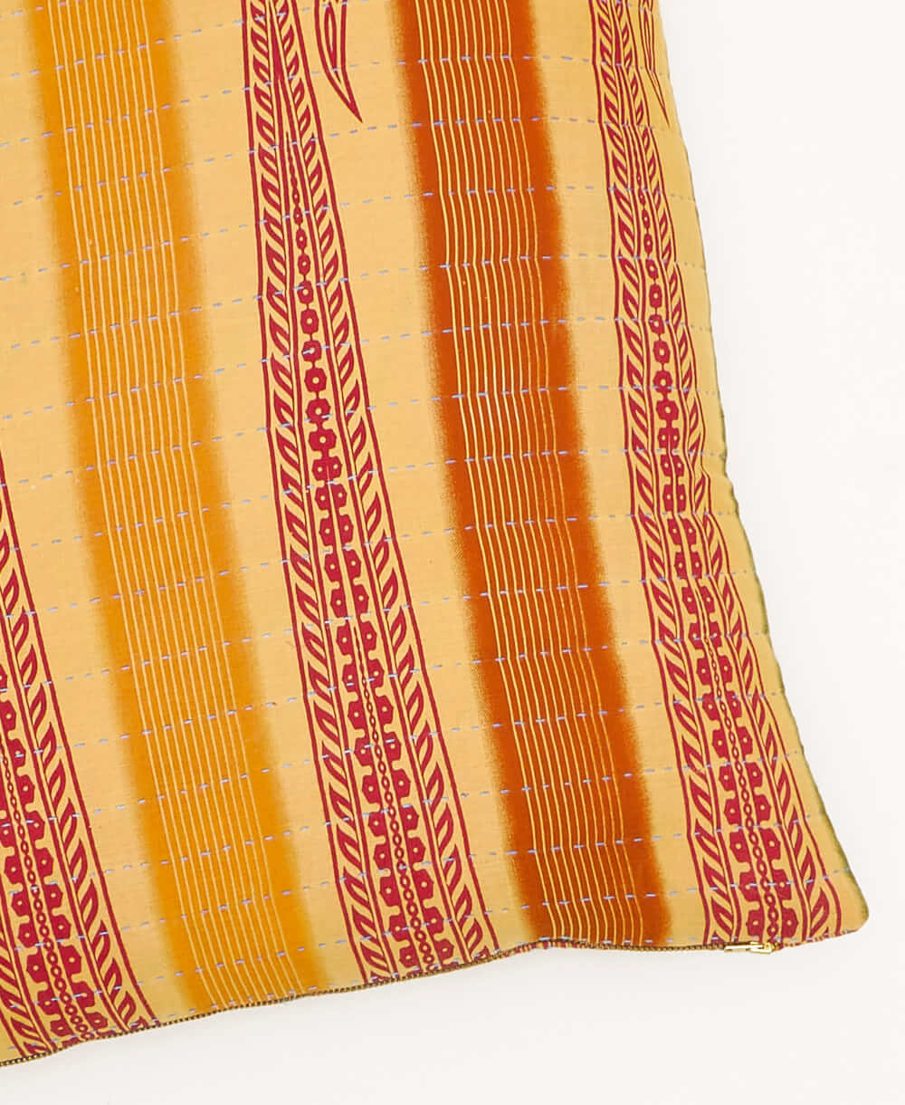 kantha square pillow in pale yellow with orange & olive stripe pattern with sky blue embroidery