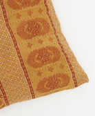 square pillow with orange embroidery