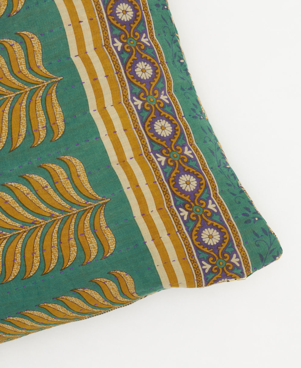 green square pillow with golden fern leaf pattern