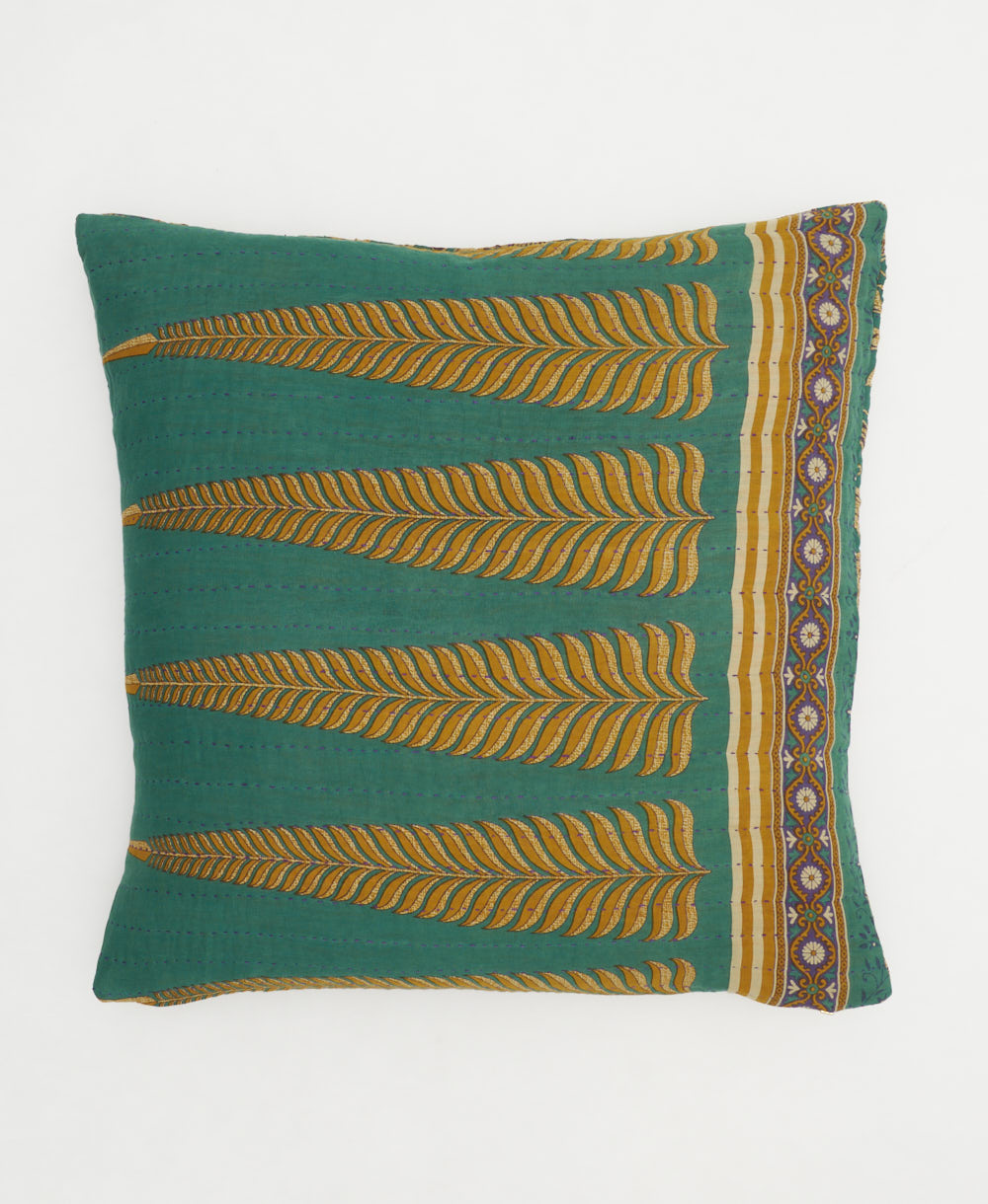 emerald green throw pillow with golden fern leaf pattern