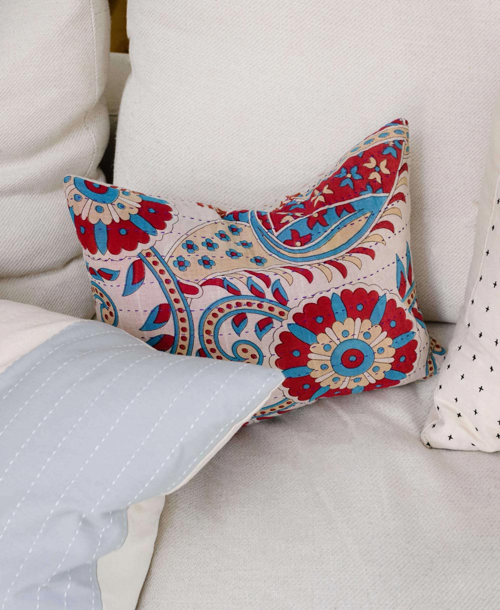 small throw pillow in red, white and blue paisley print with reversible patterns on front and back