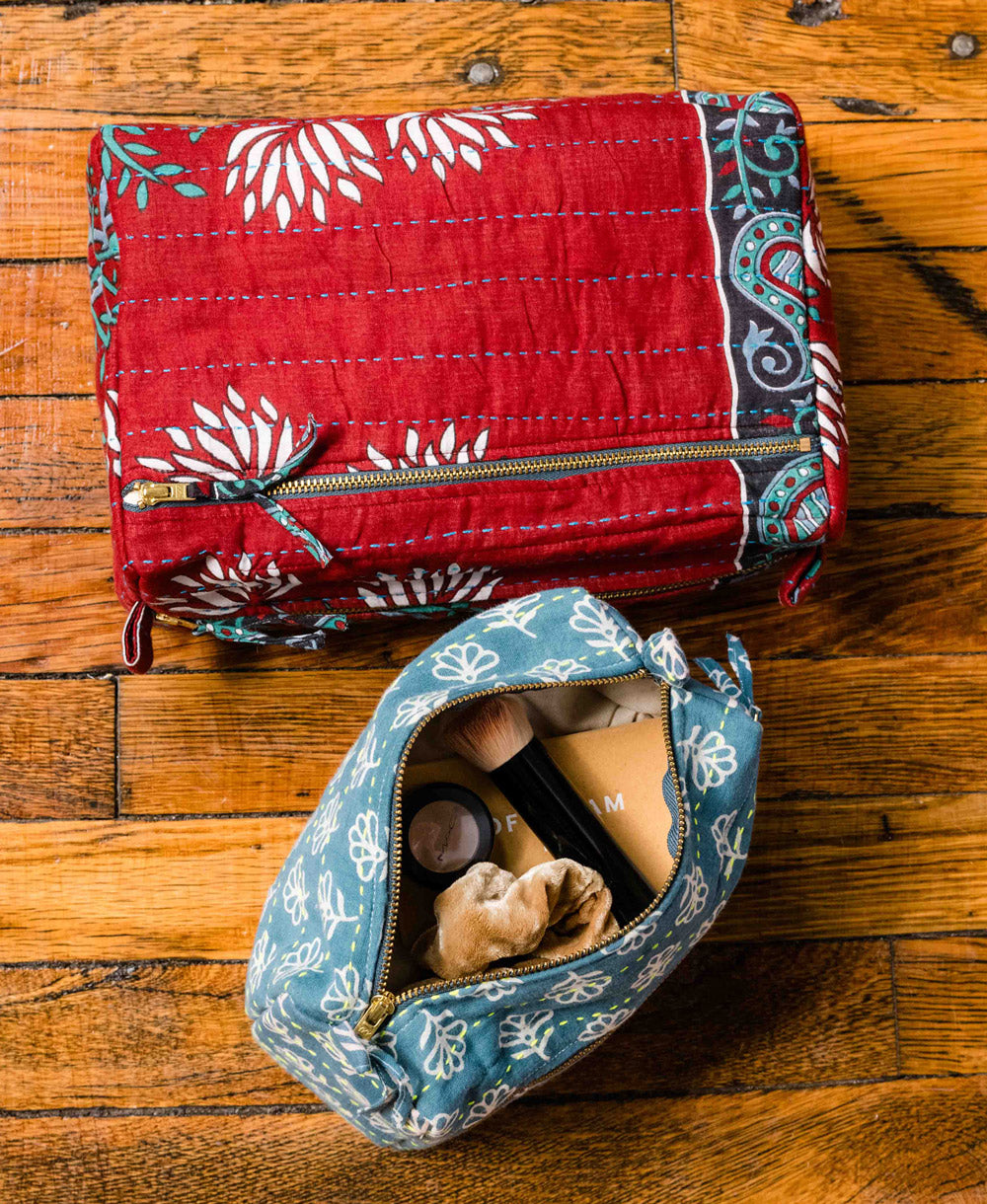 One-of-a-kind vintage kantha toiletry bags sitting on a
bathroom counter