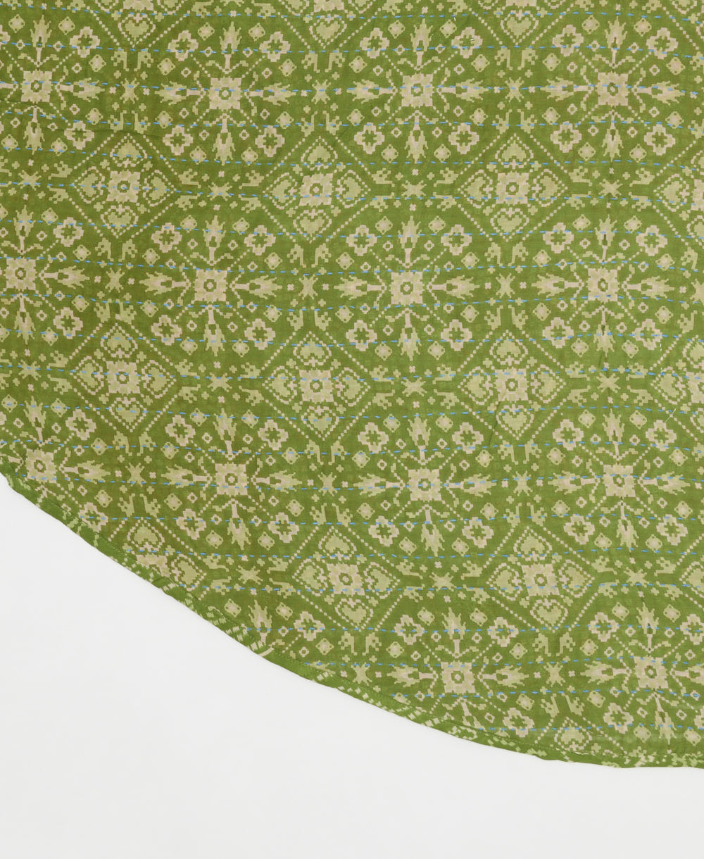 lime green reversible tree skirt made with a tan geometric medallion pattern and blue kantha stitching