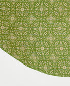 lime green reversible tree skirt made with a tan geometric medallion pattern and blue kantha stitching