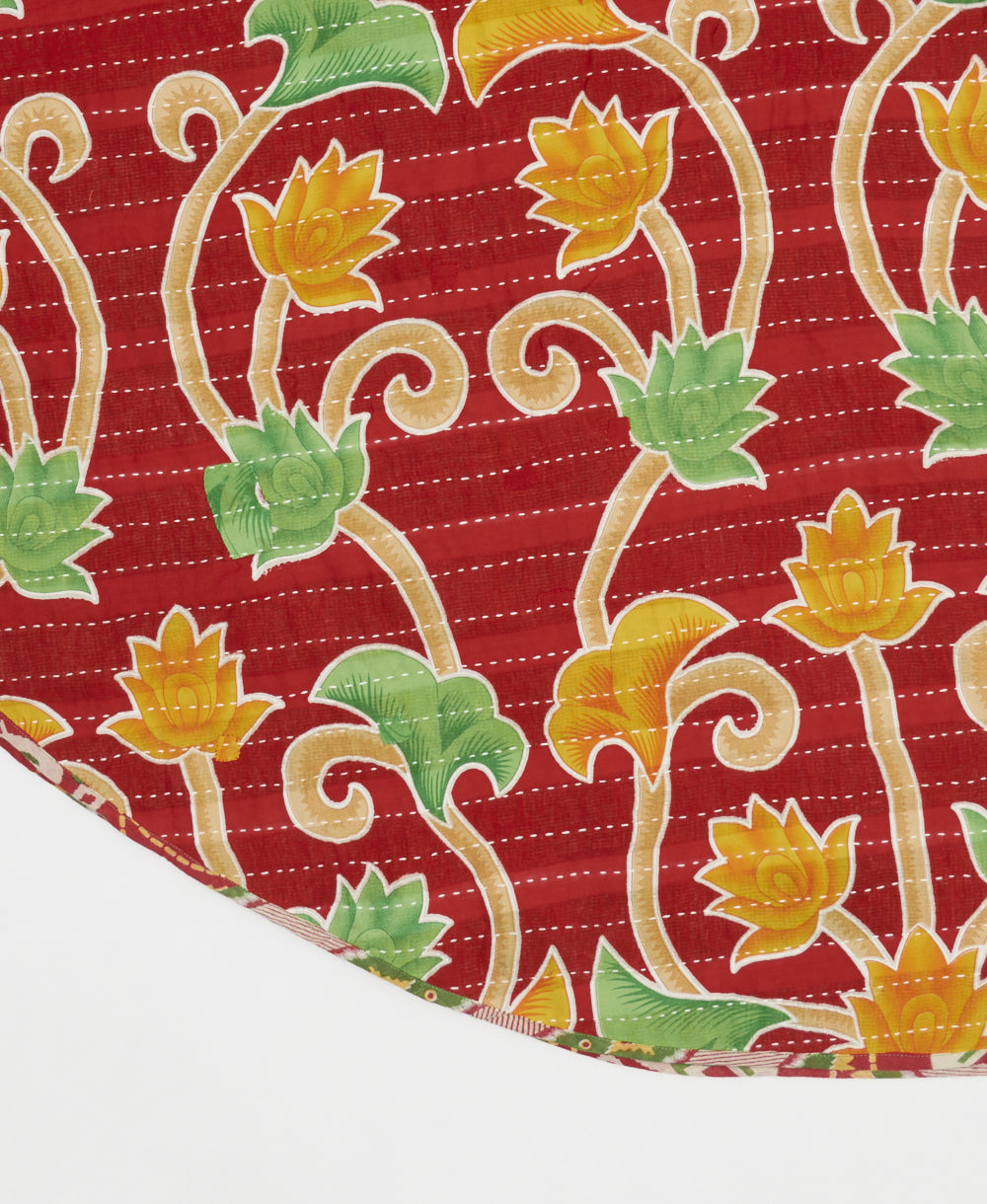 cherry red reversible tree skirt made with a marigold floral pattern and white kantha stitching