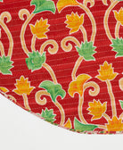 cherry red reversible tree skirt made with a marigold floral pattern and white kantha stitching