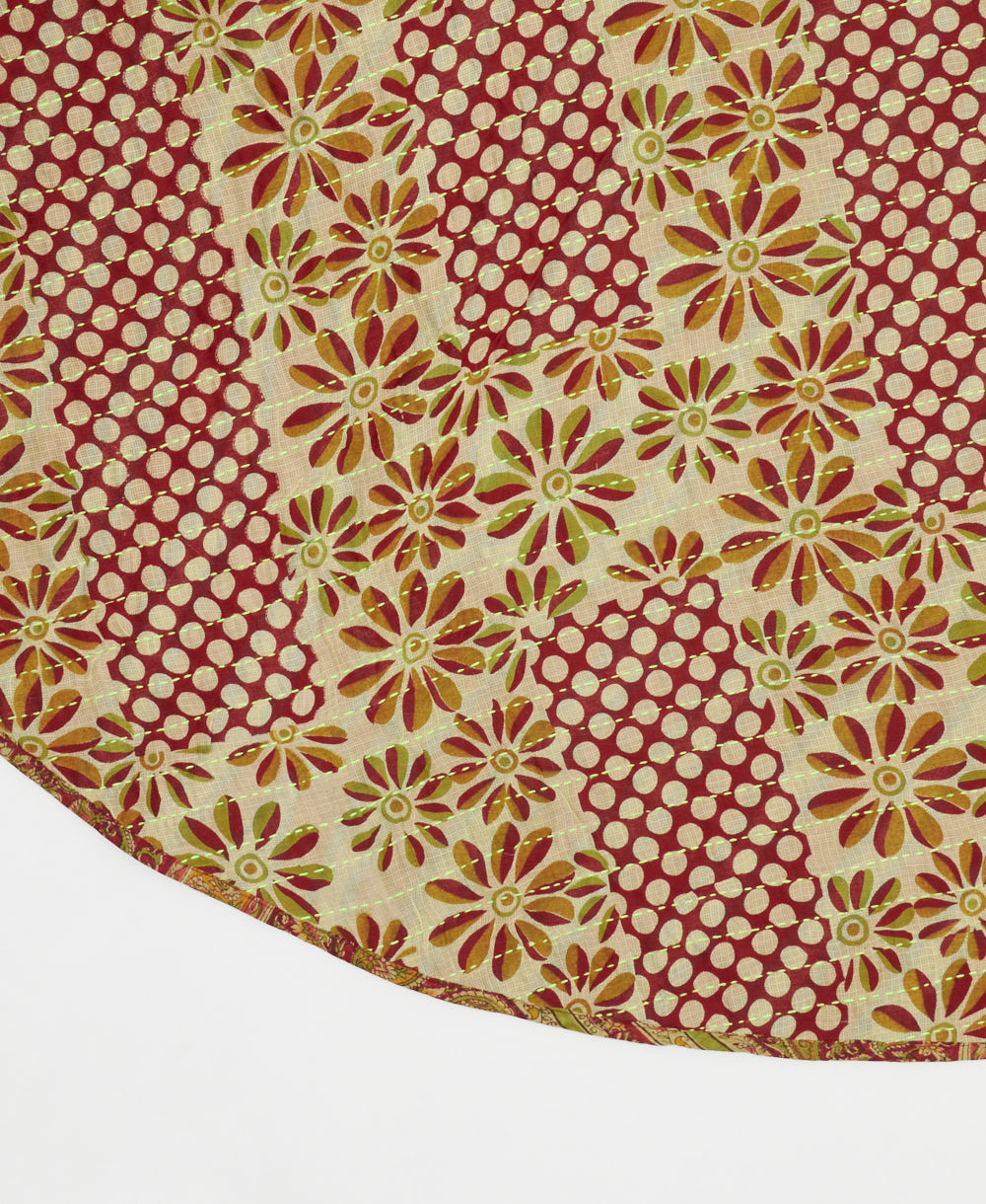 brick red & sand reversible tree skirt made with a polka dot & floral pattern with neon green kantha stitching