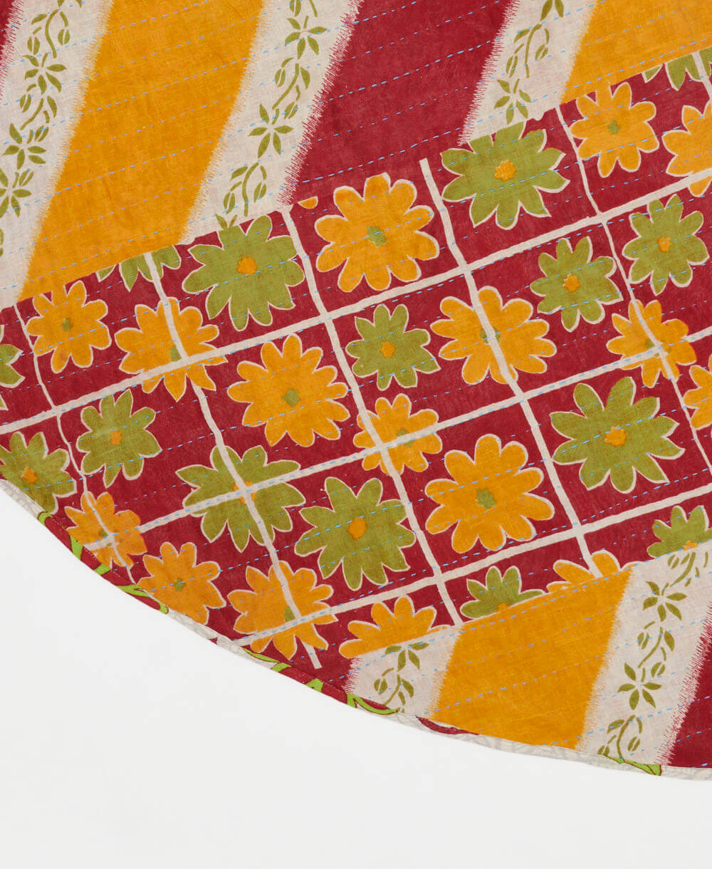 red reversible tree skirt made with olive & mustard floral pattern and blue kantha stitching