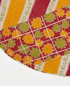 red reversible tree skirt made with olive & mustard floral pattern and blue kantha stitching