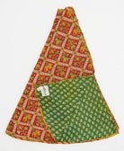 red holiday tree skirt made from vintage cotton saris featuring a novelty pattern with green floral reverse