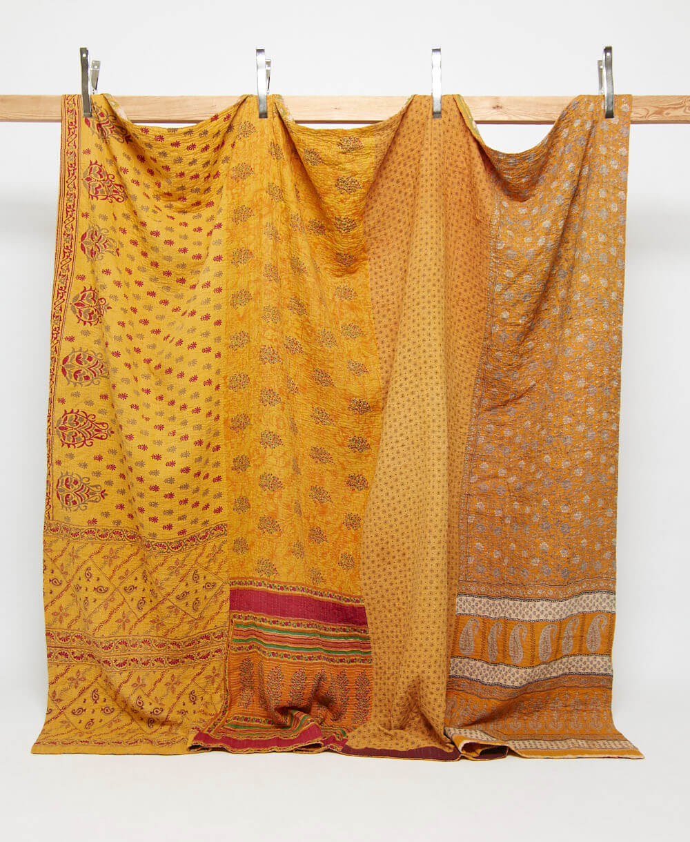 mustard yellow king kantha quilt in a red floral pattern handmade in India