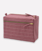 plum purple cosmetic bag with white stitching and gold zipper on a white background