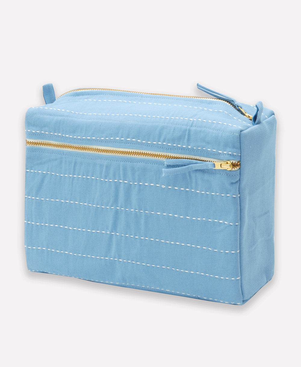light blue cosmetic bag with gold zipper on a white background