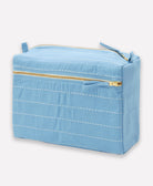 light blue cosmetic bag with gold zipper on a white background