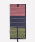 Multicolored striped travel organizer with purple, navy, and green sections on a white background