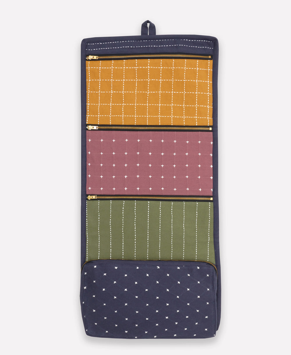 Multicolored fabric organizer with patterned sections on a white background