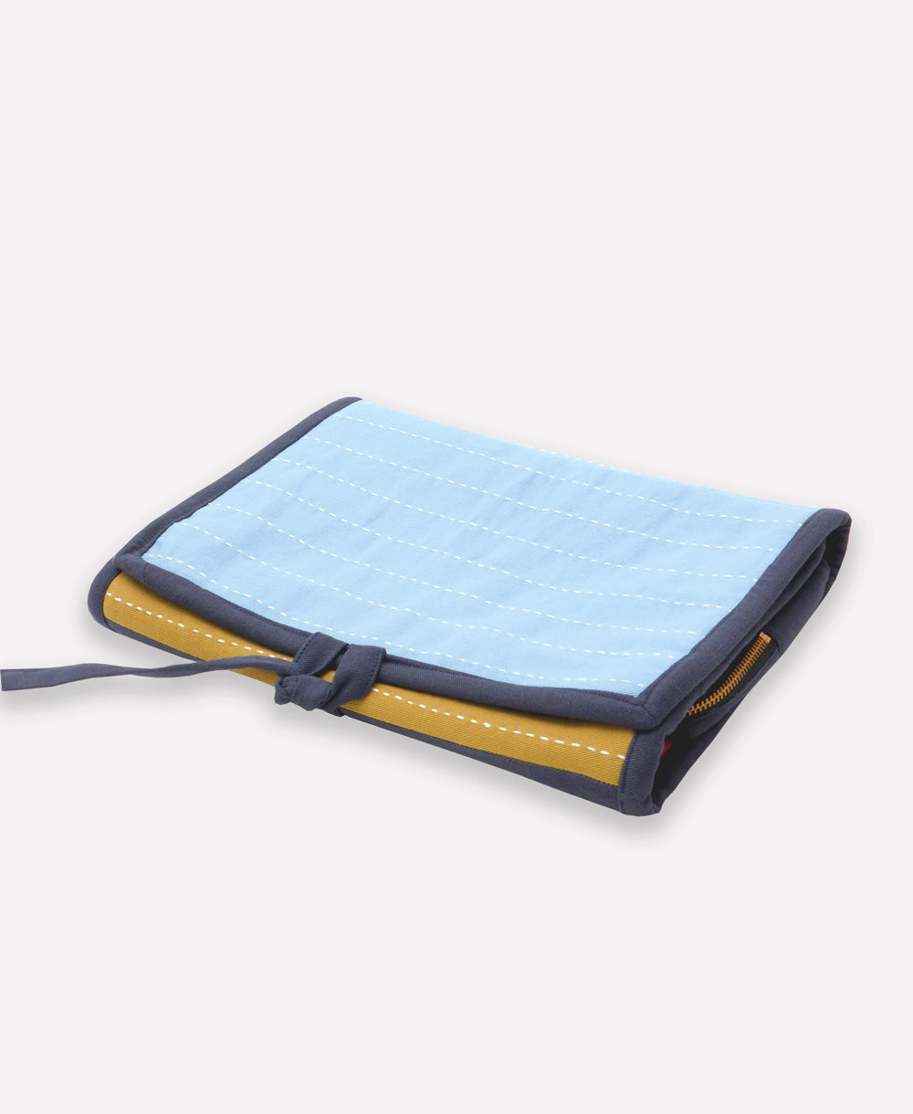 foldable travel organizer made from organic cotton with sky blue, ochre yellow and orange