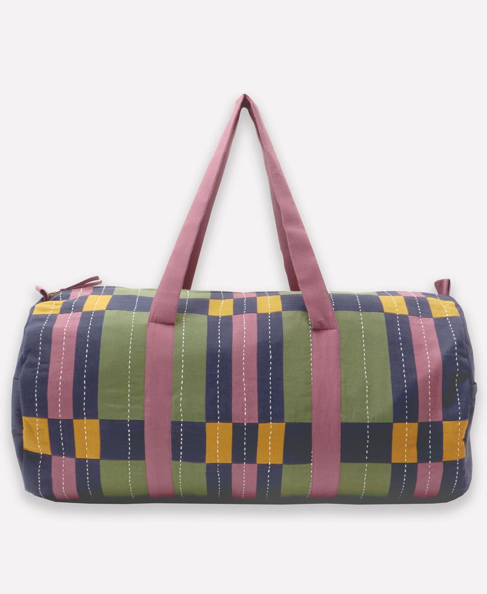 Checkered duffel bag with pink straps on a white background