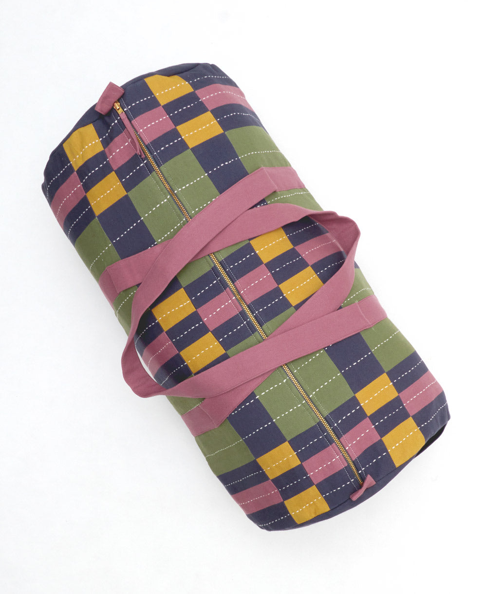 Colorful checkered bag with a pink strap on a white background