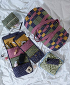 Set of fabric bags and organizers with checkered pattern on a white background