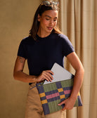woman holding lattice latop case in berry