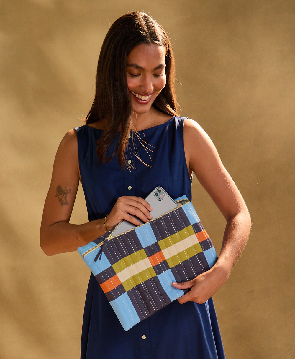 woman holding colorful laptop case in navy