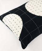 Black and white patterned pillow on a white background