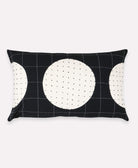 Black pillow with white circular patterns on a white background