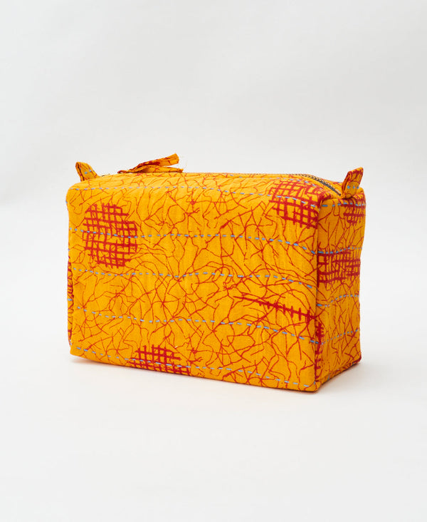Orange and red abstract vintage kantha toiletry bag featuring blue
traditional kantha hand stitching
