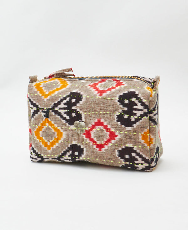 Orange and red geometric print vintage kantha toiletry bag featuring neon green 
traditional kantha hand stitching
