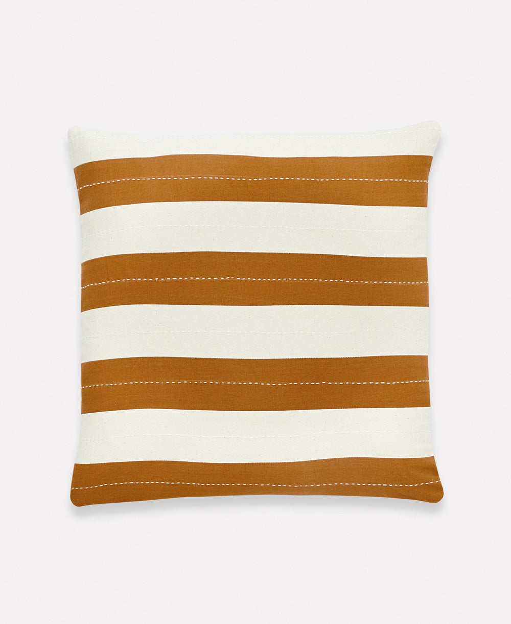 camel and white striped throw pillow with hand embroidery made by women artisans