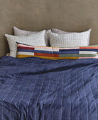 ethically made organic cotton bedding with solid navy blue quilt back that's reversible