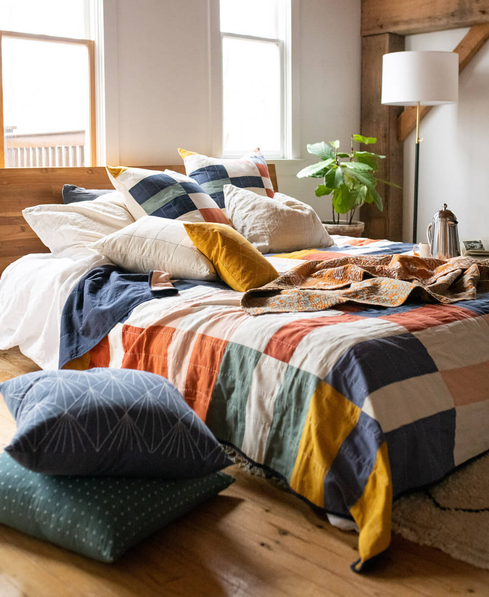 modern rustic bedroom with colorful checkered quilt and matching euro shams in organic cotton