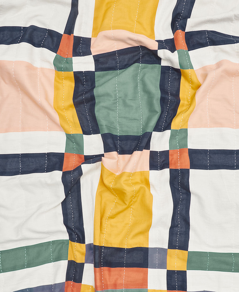 colorful baby quilt in a bold plaid design handmade from 6 layers of organic cotton