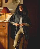 woman wearing black quilted jacket with white embroidery