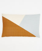 angled lumbar pillow in modern patchwork design in shades of light blue, natural white and camel with various embroidery patterns